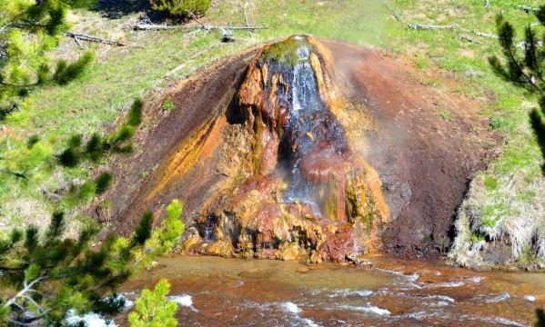 Yellowstone's Chocolate Pots have green, yellow, brown and orange streaks formed by warm, water loving bacteria and algae.