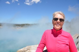 Carol posing in front of Yellowstone's Prismatic Spring