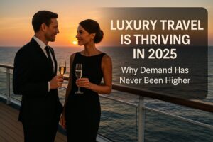 Elegant couple enjoying champagne on the deck of a luxury cruise ship at sunset, symbolizing the thriving luxury travel market in 2025.