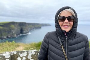 Carol bundled in a warm jacket at the Cliffs of Moher on Ireland's Atlantic coast during a chilly and windy July visit.