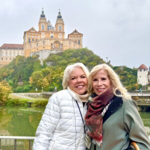 Carol Porter and a fellow traveler visiting Melk Abbey in Austria, one of Europe's iconic cultural landmarks and a popular stop on Danube River cruises.