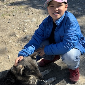 Ryan petting one of Martin Buser's friendly sled dogs during our Tauck Bridges Call of the Wild adventure in Alaska.