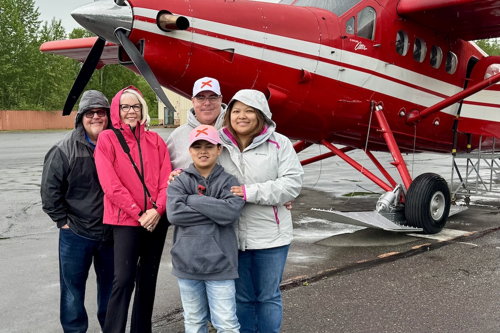 Three generations of our family standing in front of a bush plane during our Tauck Bridges Call of the Wild multigenerational family adventure in Alaska.