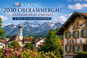 Scenic view of Oberammergau, Germany, featuring its famous painted Bavarian buildings, church, and the Alps, promoting Viking's 2030 Oberammergau Passion Play cruises.